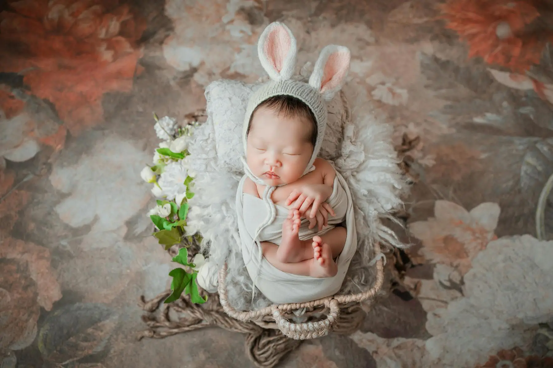 Newborn resting peacefully in a cot during the first month of life